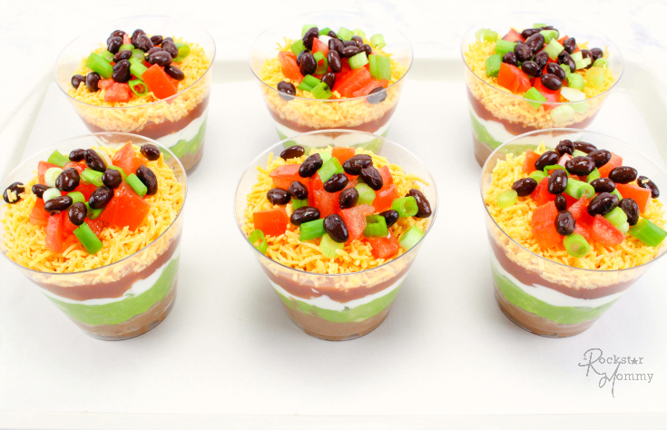 Mexican Bean Dip Cups - Appetizer cups on a plate