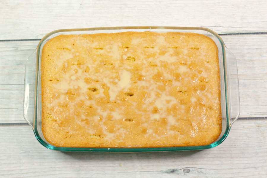 Caramel Tres Leches Cake - cooked cake with holes poked in it