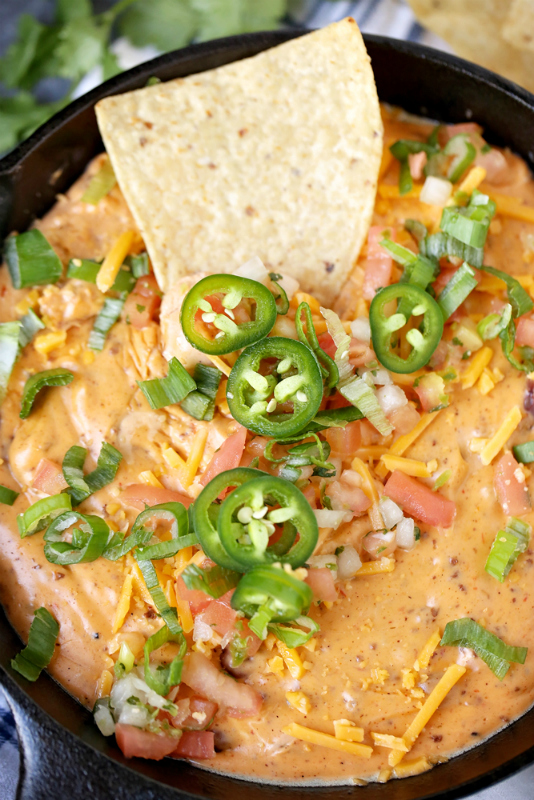 Oven or Crockpot Chili Cheese Dip - hot chili dip served in cast skillet pan with tortilla chips