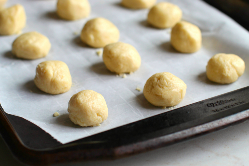 Cookie dough rolled into balls on cookie sheet