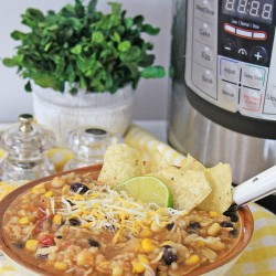Instant Pot Mexican Chicken and Rice Soup served in a white bowl, with Instant Pot in the background