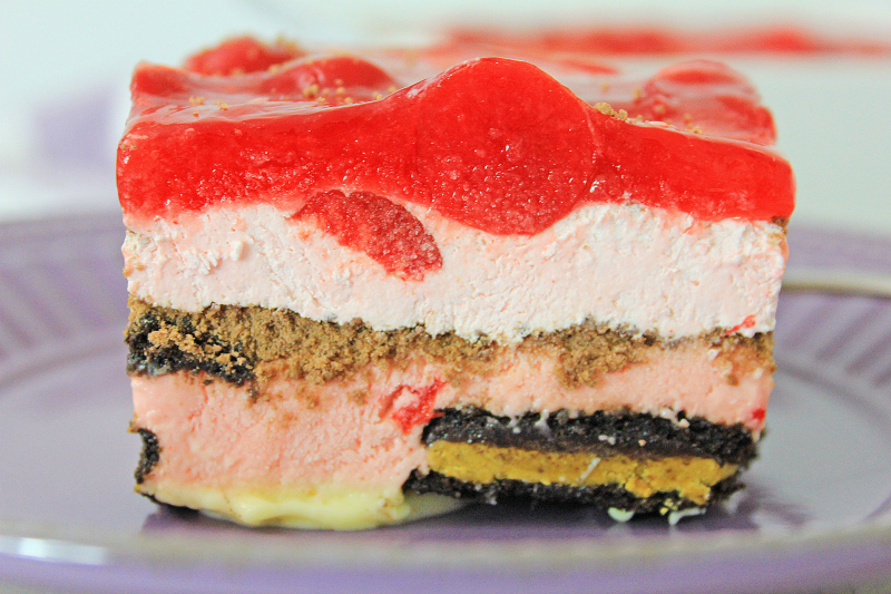 side view of a slice of Chocolate Cherry Oreo Icebox Cake on a purple plate