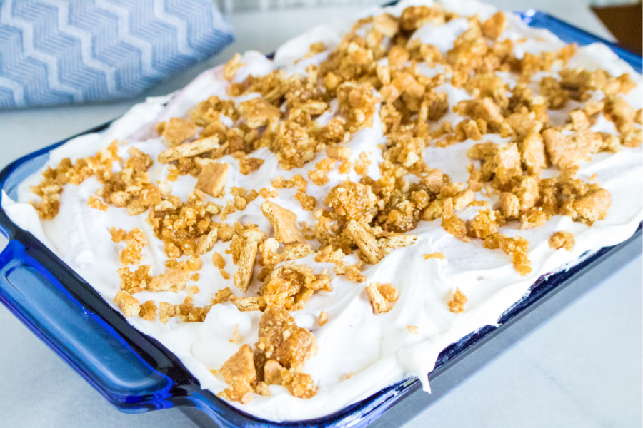  cake topped with whipped cream and graham cracker topping