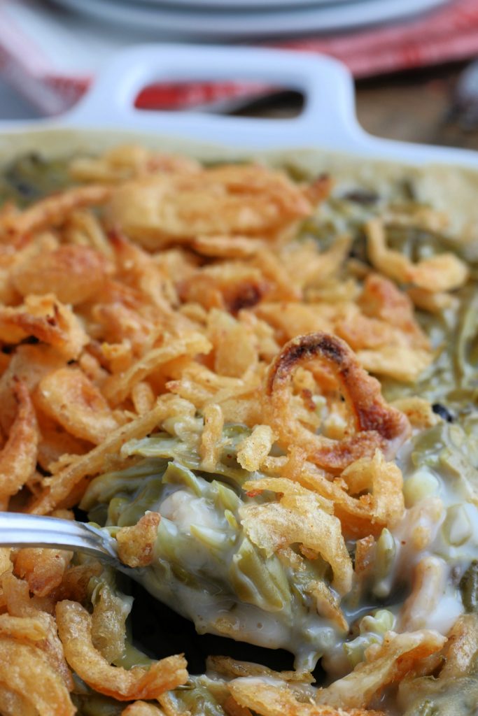 Easy Green Bean Casserole in a baking dish, with a spoon scooping out some