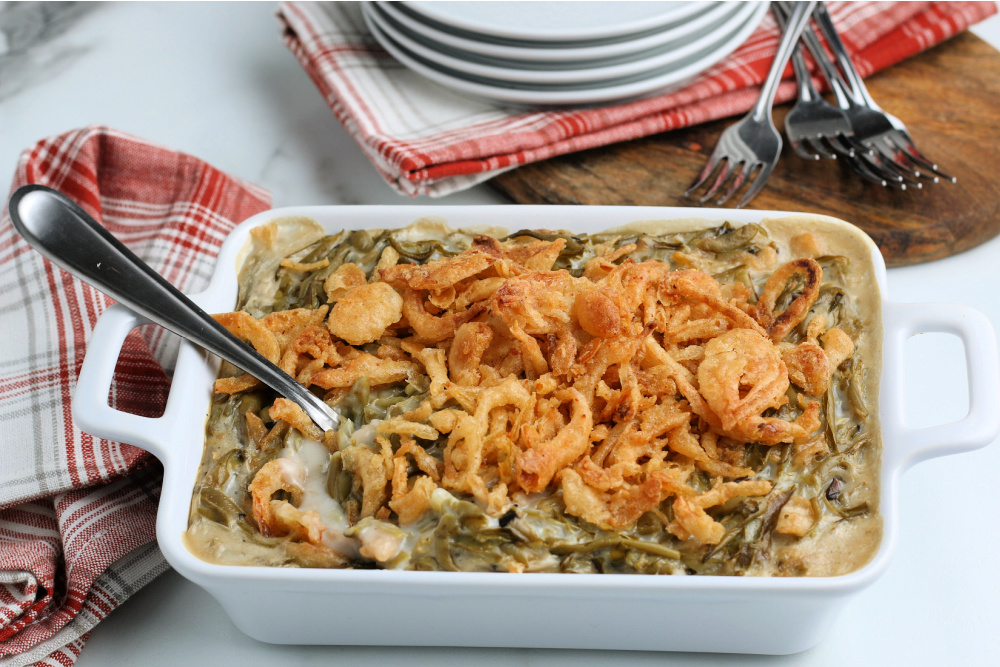 cooked easy green bean casserole in a white baking dish