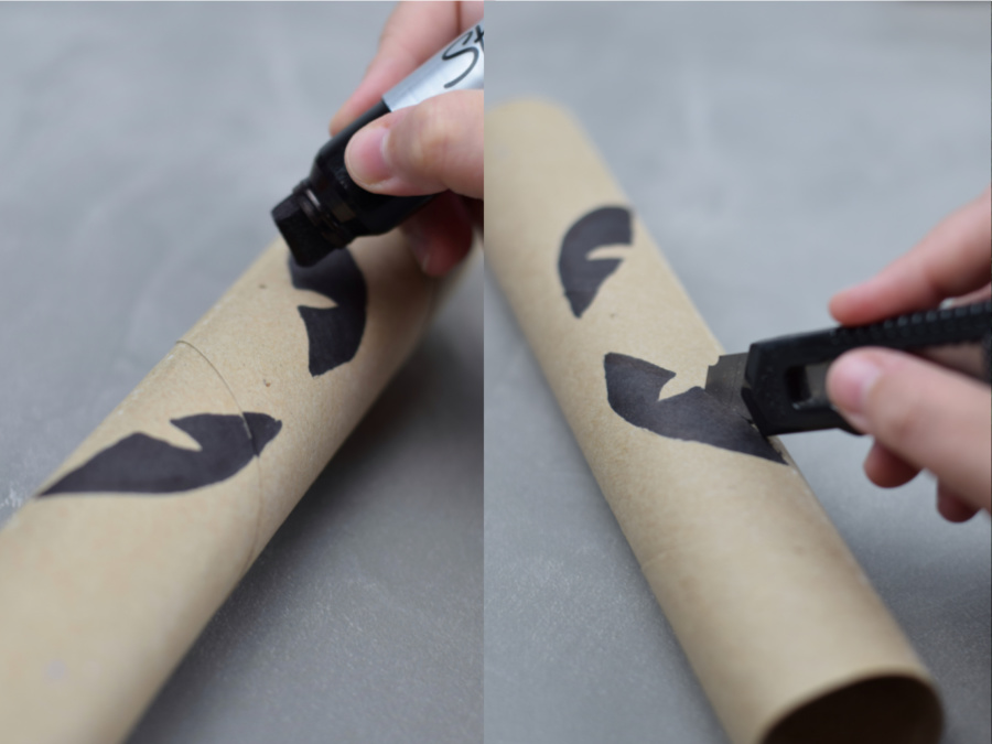 eyes being draw on a paper towel roll and cut out with a knife