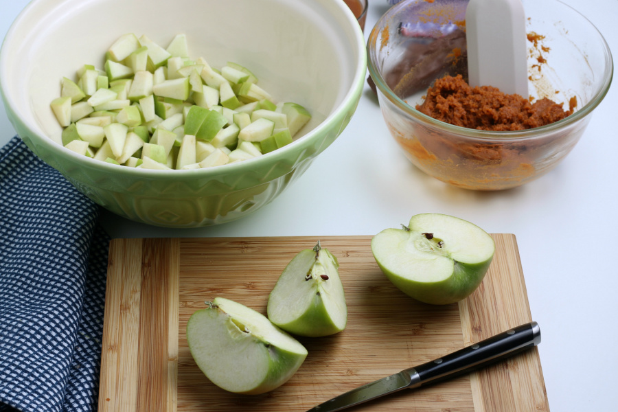green apples being cut on cutting board