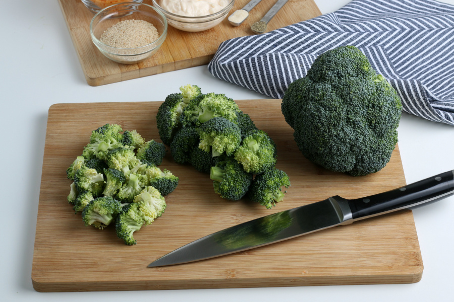 cut up broccoli on a cutting board