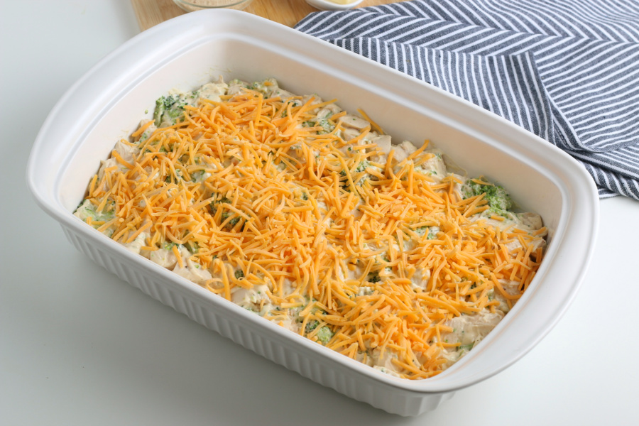 chicken mixture in a baking dish topped with shredded cheese