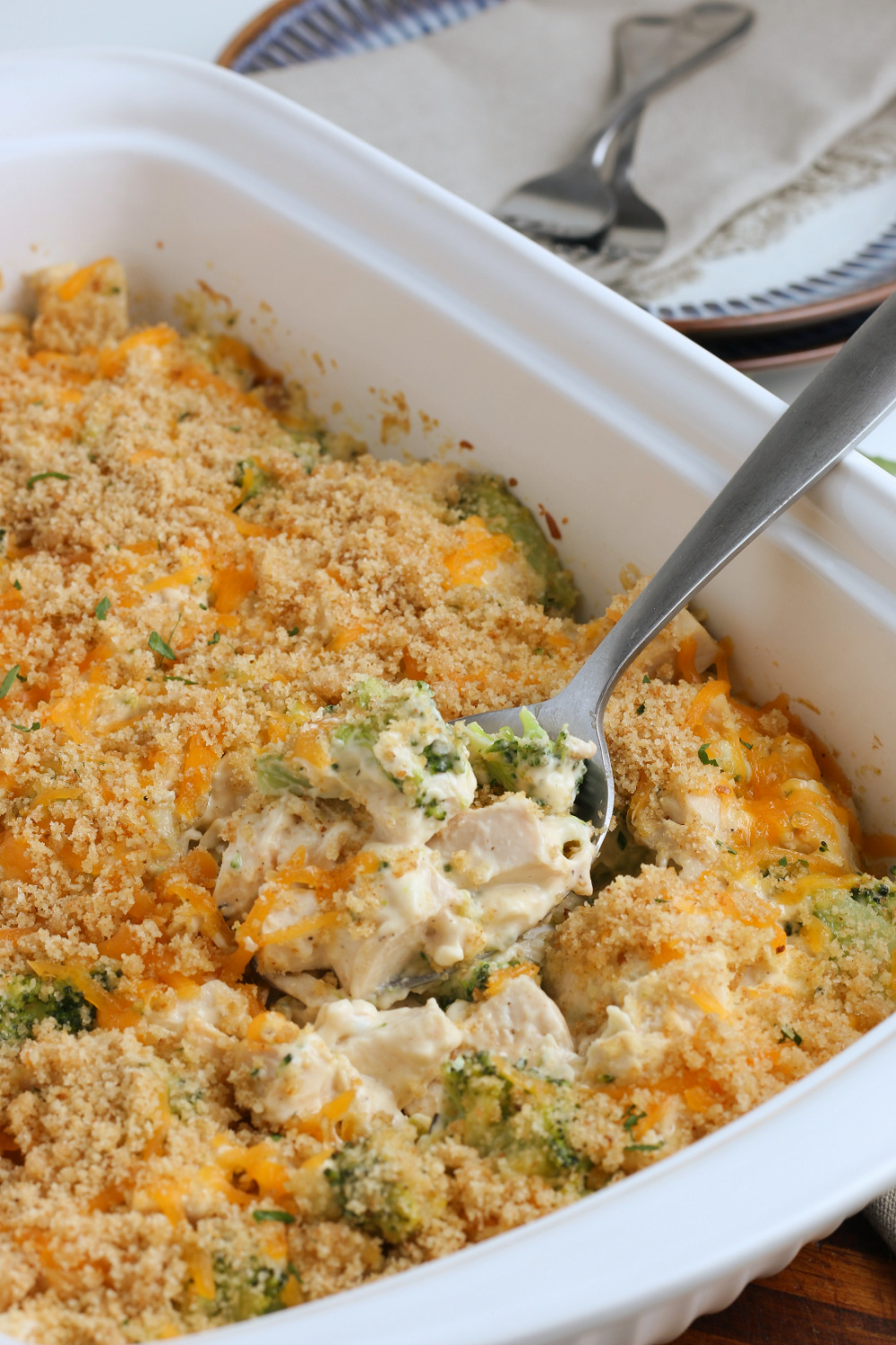Creamy Chicken Divan in a casserole dish with a serving spoon