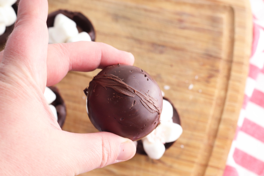 placing chocolate mold on top of bottom chocolate mold