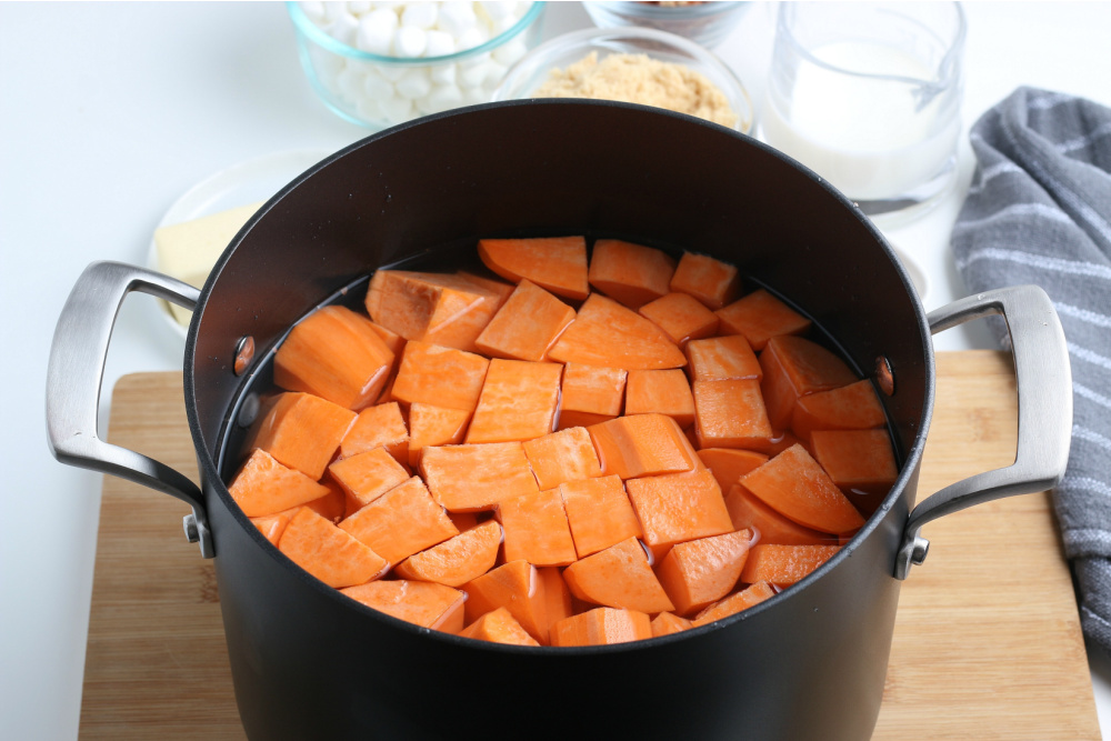 Sweet potato chunks in a cooking pot with water