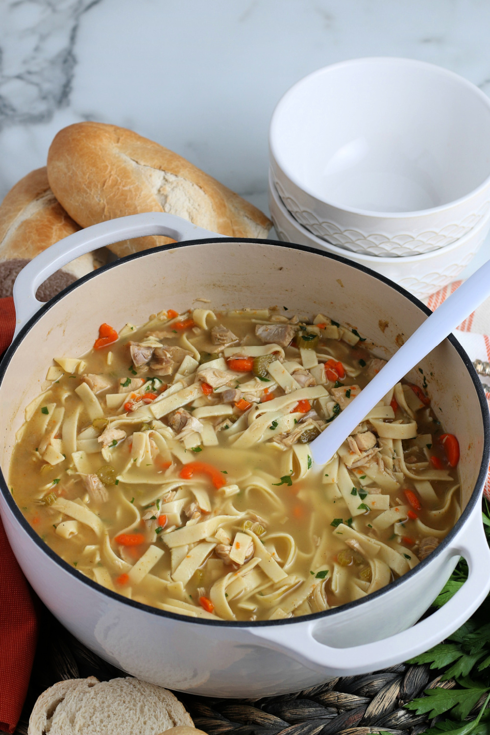 Turkey Noodle Soup in a large soup pot with a serving spoon
