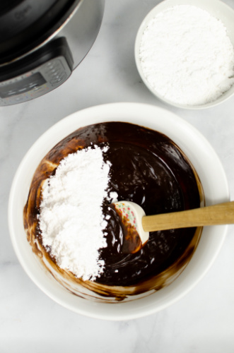 stirring in powdered sugar