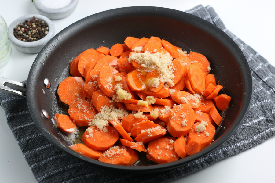carrots, brown sugar, honey and garlic added to a frying pan