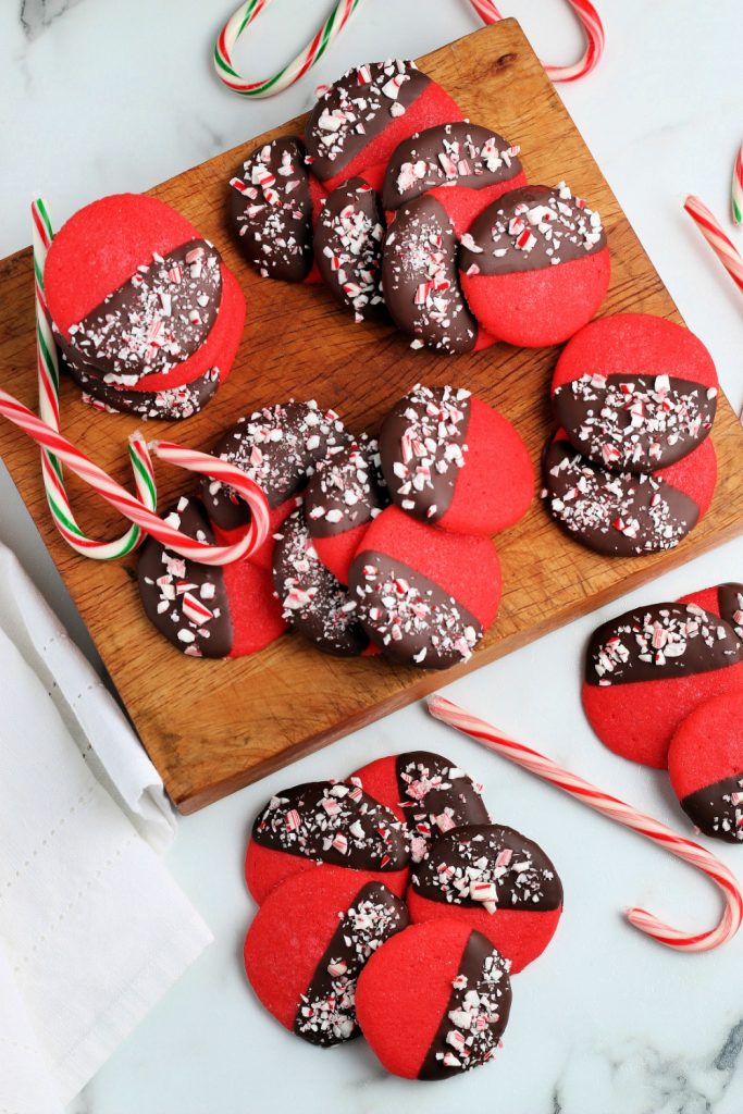 Peppermint Dipped Cookies on a wooden board