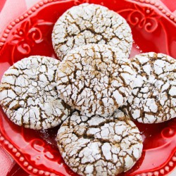 Gingerbread Crinkle Cookies stacked on a red plate