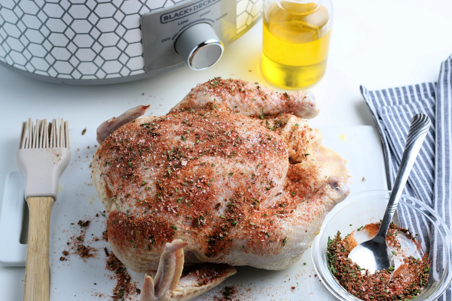 seasoning rubbed on whole chicken
