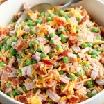Classic Ham and Pea Salad in a serving bowl with a spoon