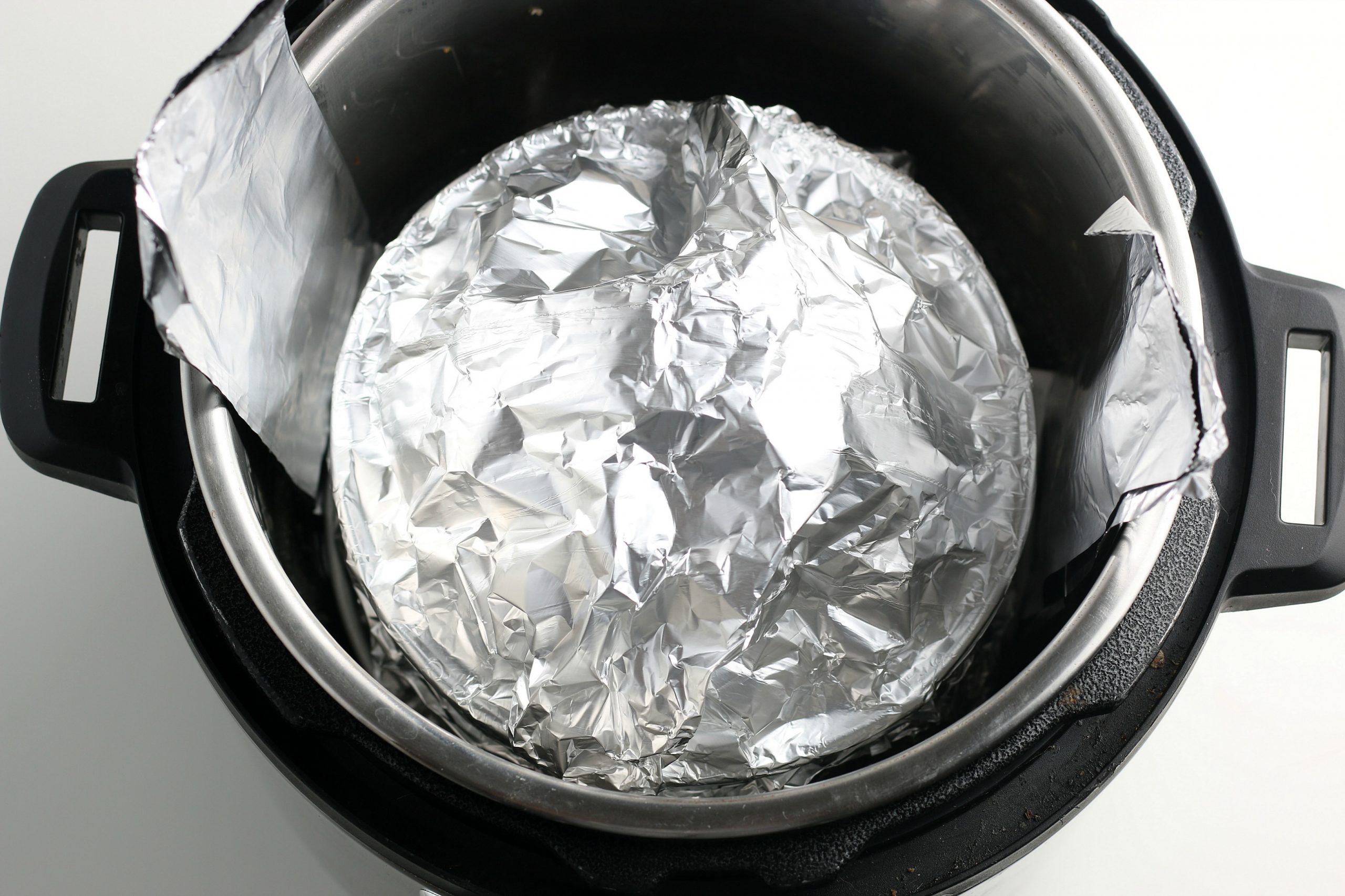 placed foil covered spring form pan into instant pot