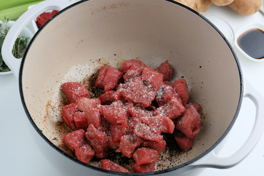 chunks of seasoned beef in large soup pot