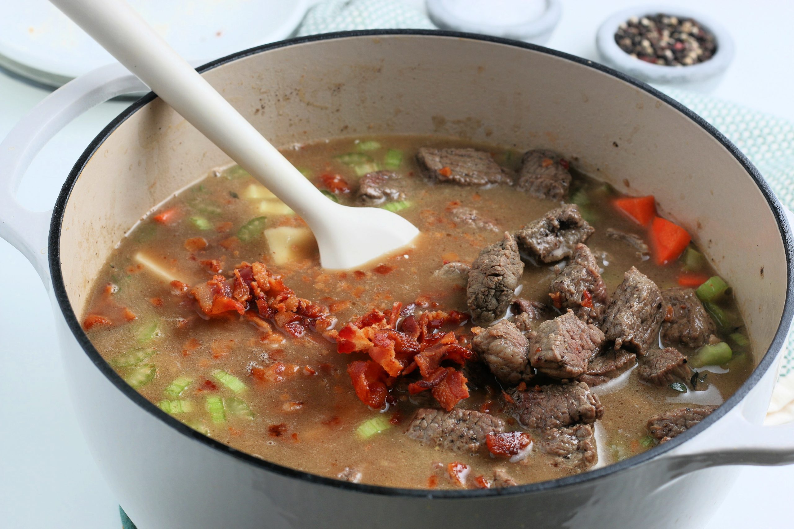 returning cooked beef to soup pot