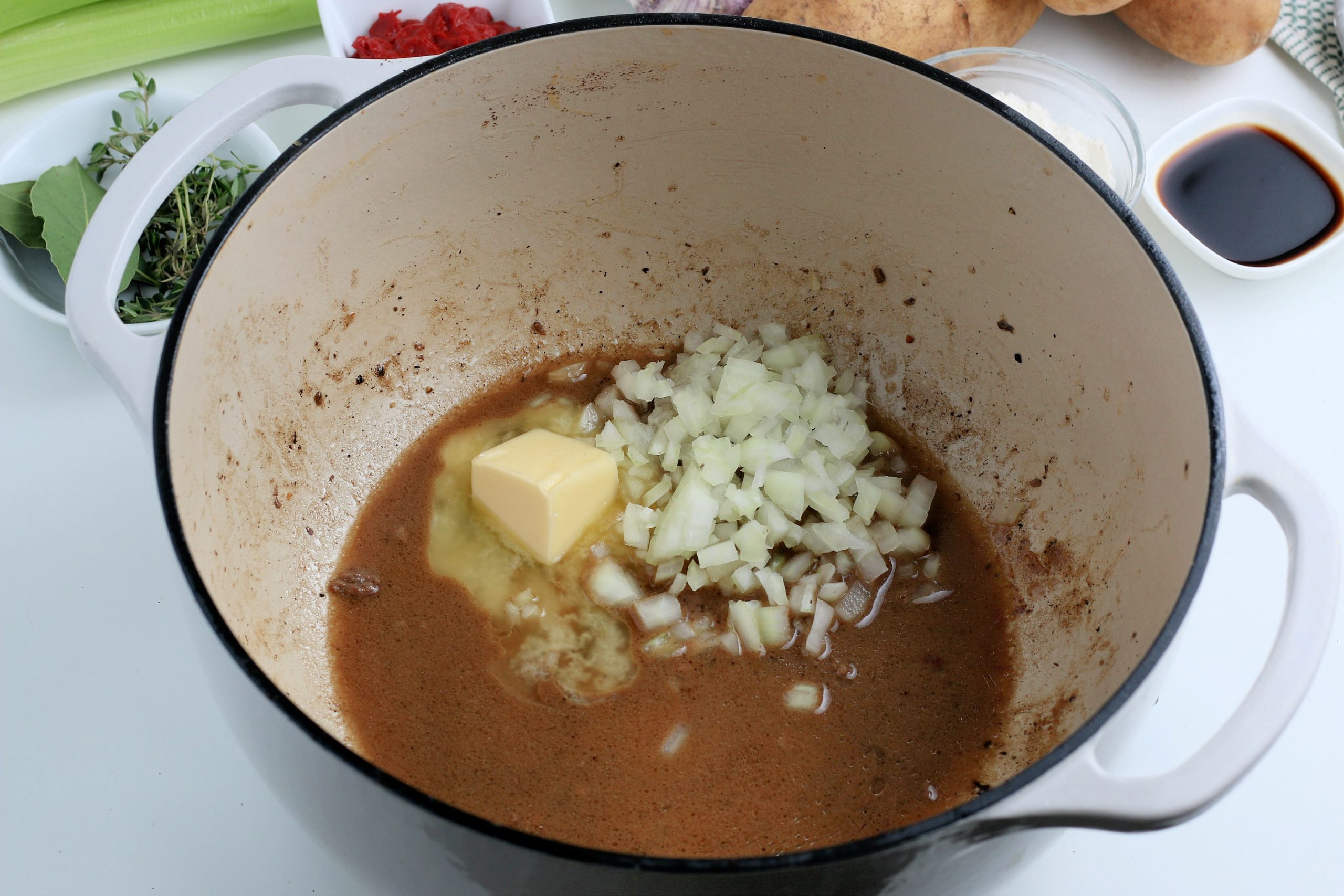 butter and onions being added to pot