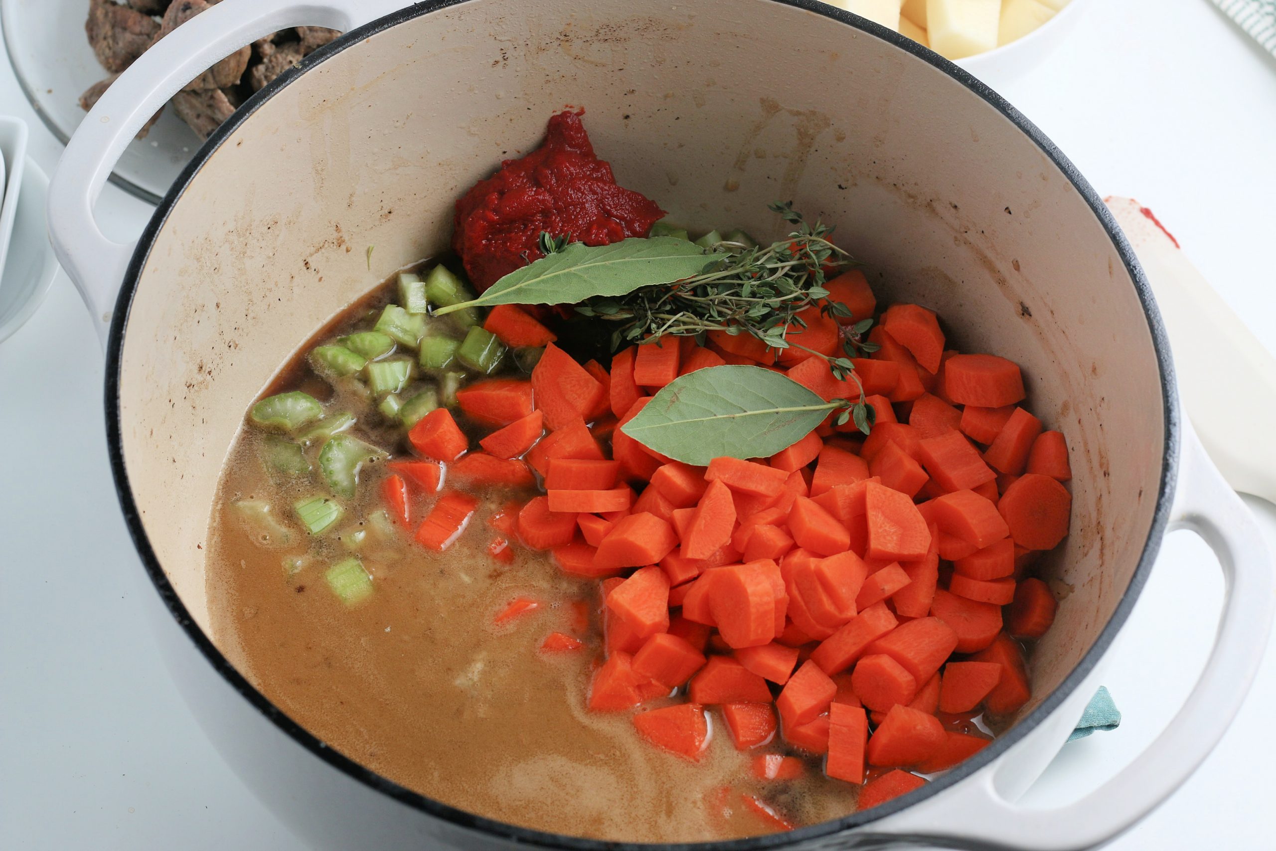 tomato paste, chicken, stock carrots, parsnips, Worcestershire sauce, celery, bay leaves and thyme into cooking pot