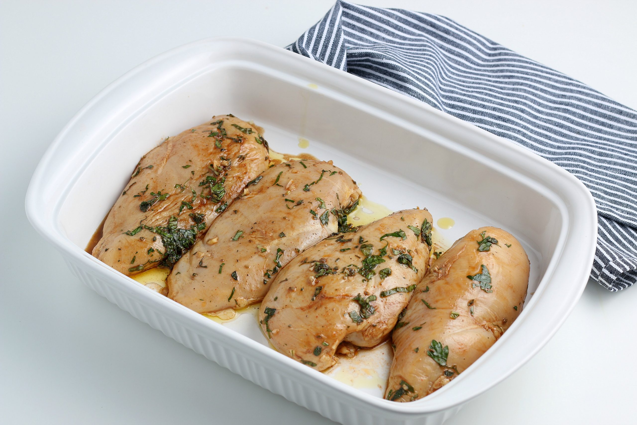 4 marinaded chicken breast in a baking dish