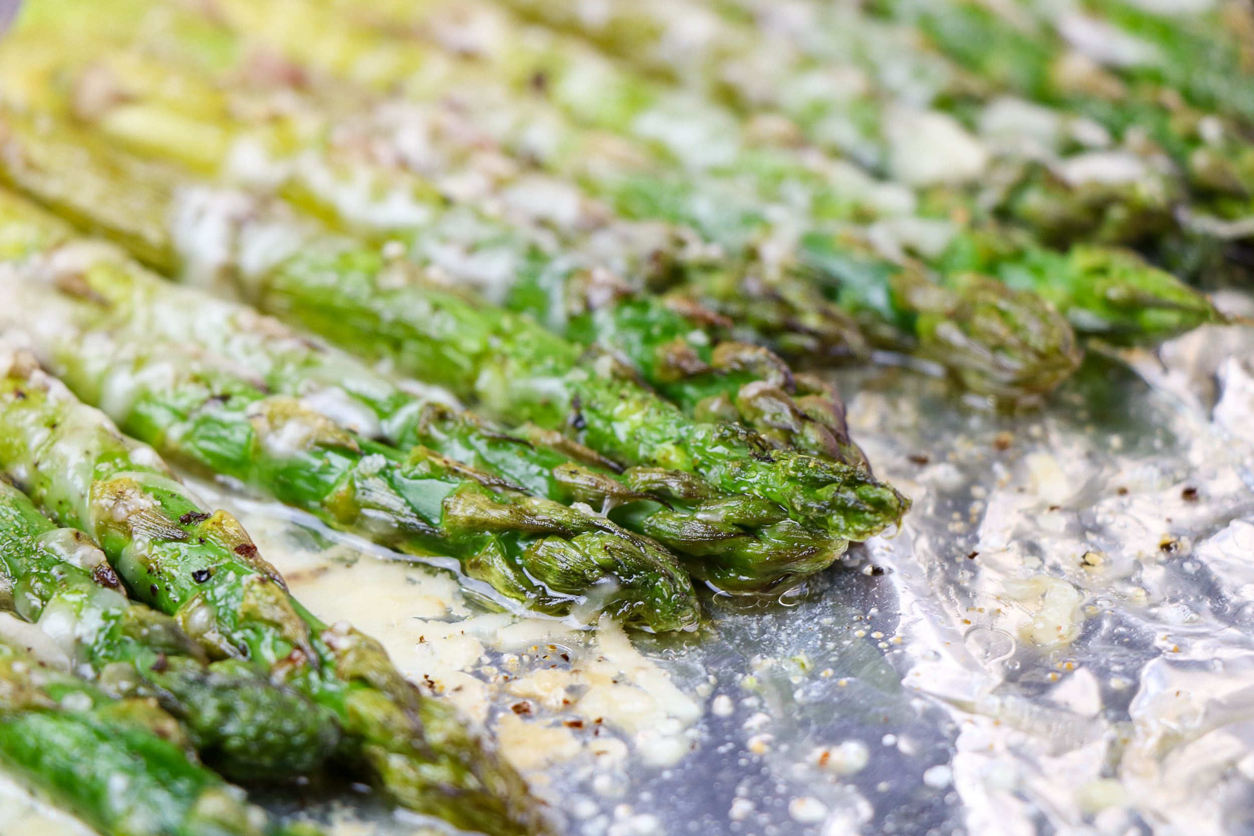 roasted asparagus on a foil lined baking sheet