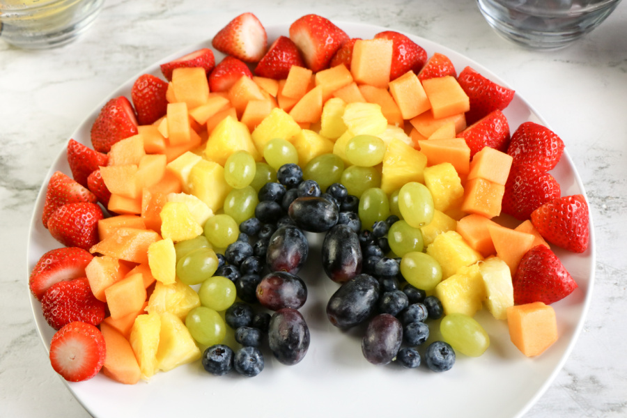 fruit arranged on a platter to look like a rainbow