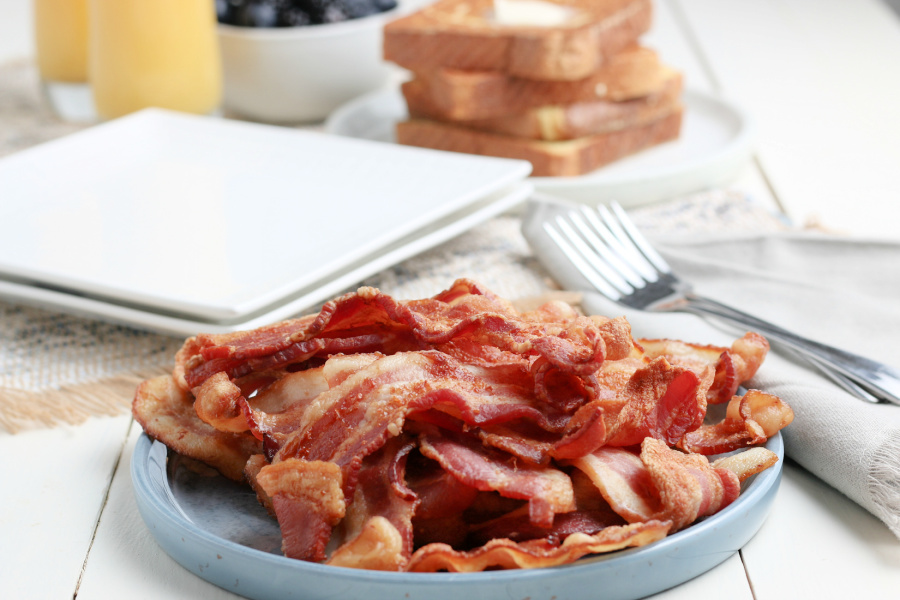 pile of cooked bacon a a plate