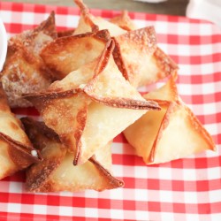 air fryer crab rangoon stacked on a plate