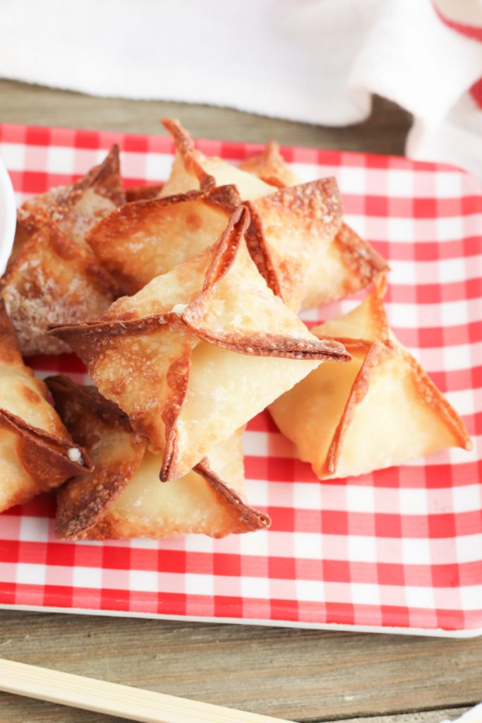 air fryer crab rangoons stacked on a plate