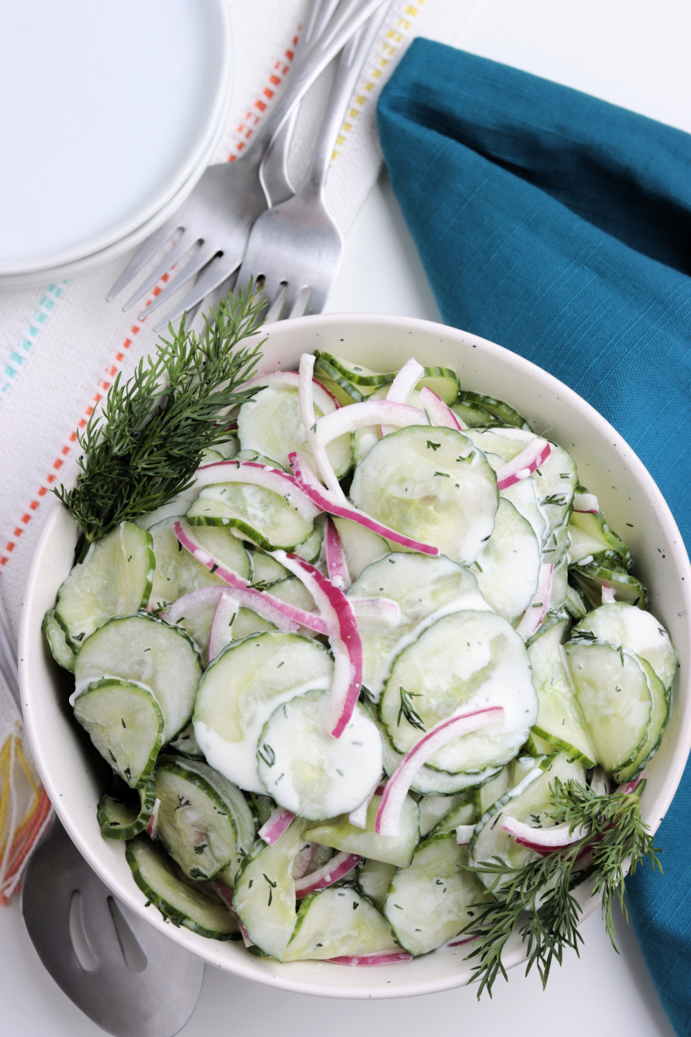 Creamy cucumber salad in a white bowl