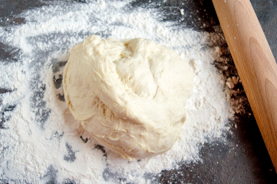 Ball of pizza dough on a floured surface