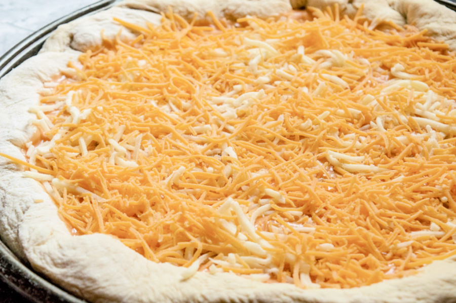 shredded cheese place on dough