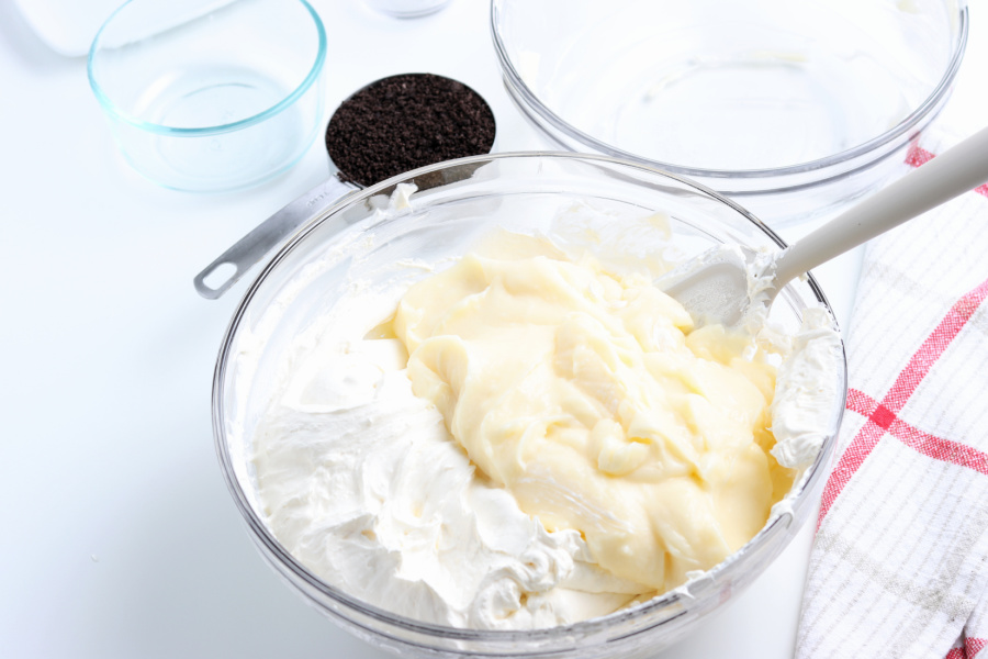 pudding mixture being mixed into whipped cream mix