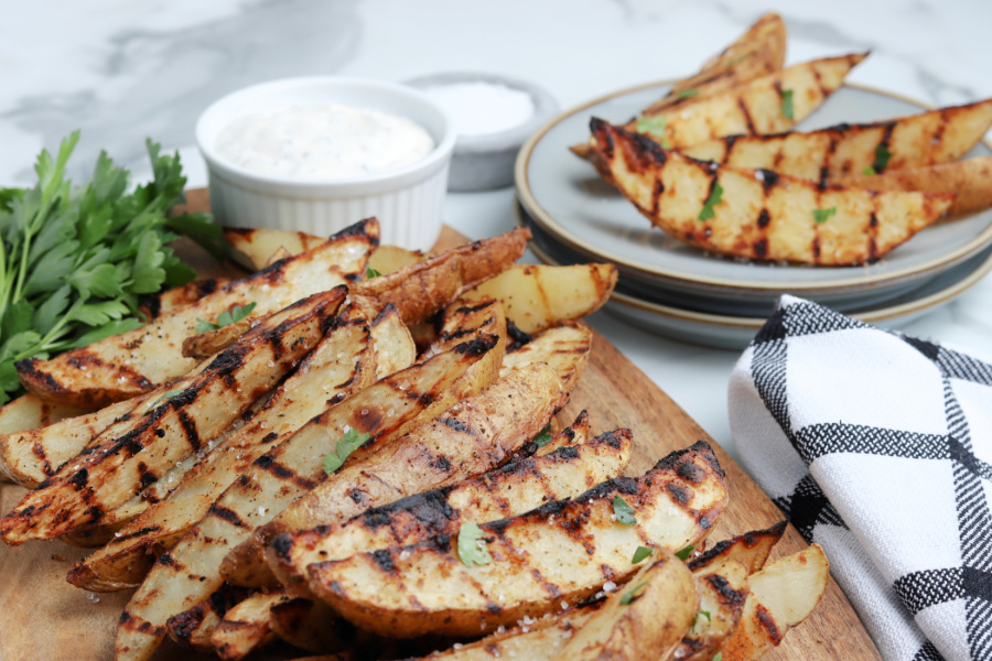 grilled potato wedges on cutting board