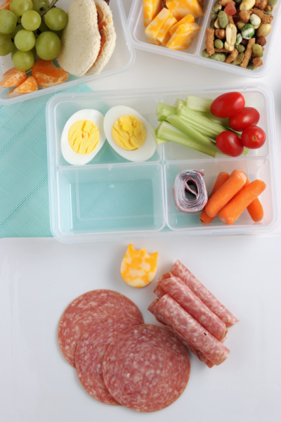 lunchbox with food being added in