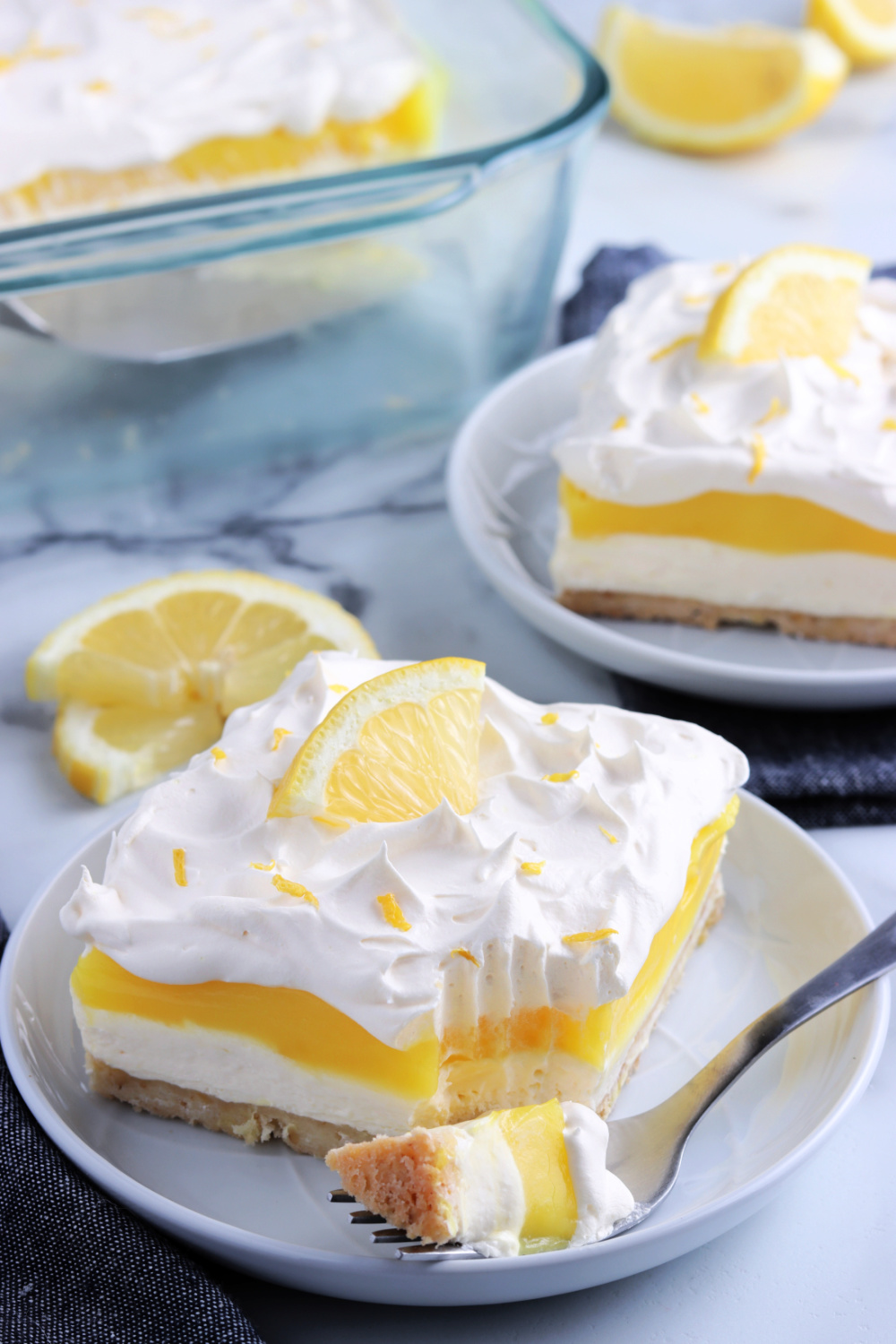 two pieces of lemon lush cake on plates