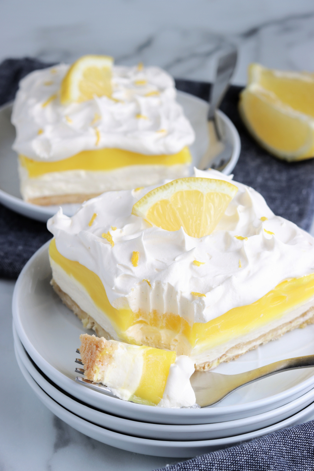 two pieces of lemon lush cake on plates
