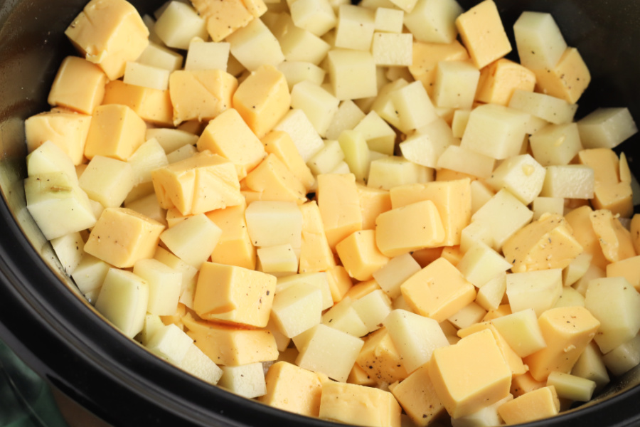 cubed potatoes and cheese in slow cooker