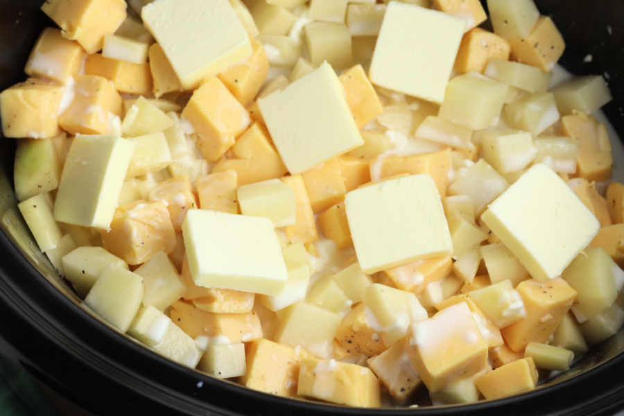 cubed potatoes, cheese and butter in slow cooker