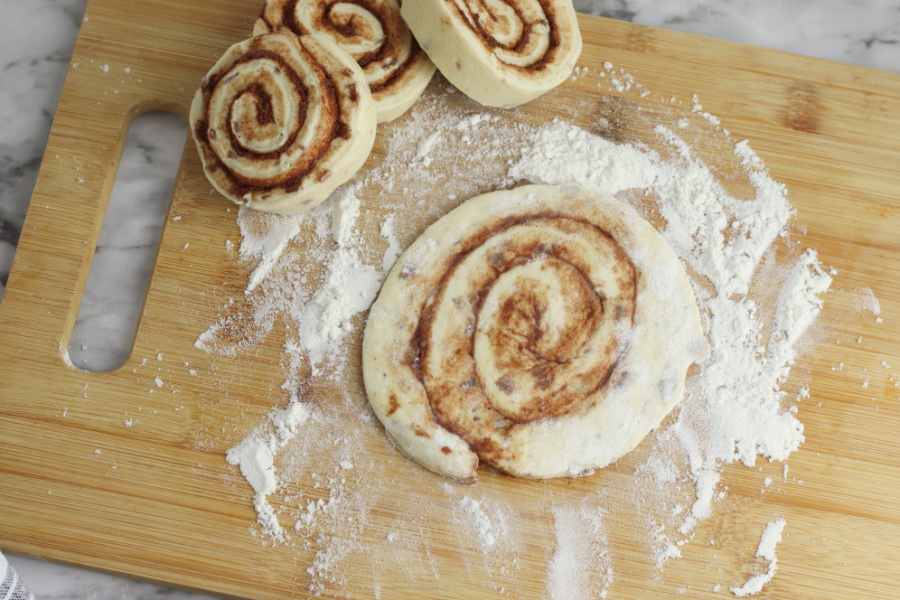 cinnamon rolls rolled out on cutting board