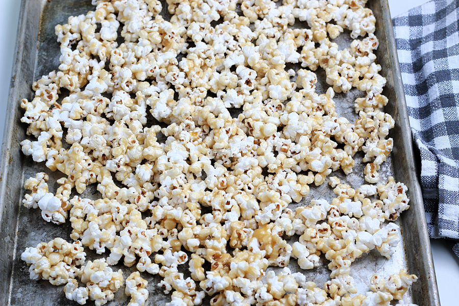 popcorn spread out on baking sheet