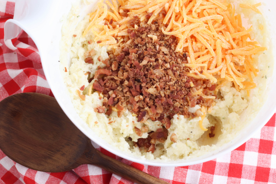 bacon and cheddar added to potato bowl