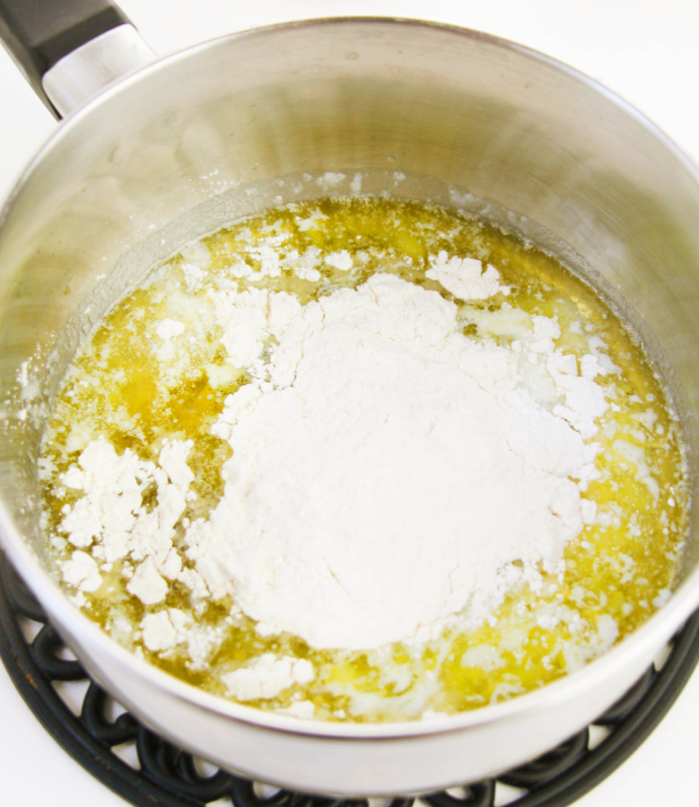adding flour to pot with butter