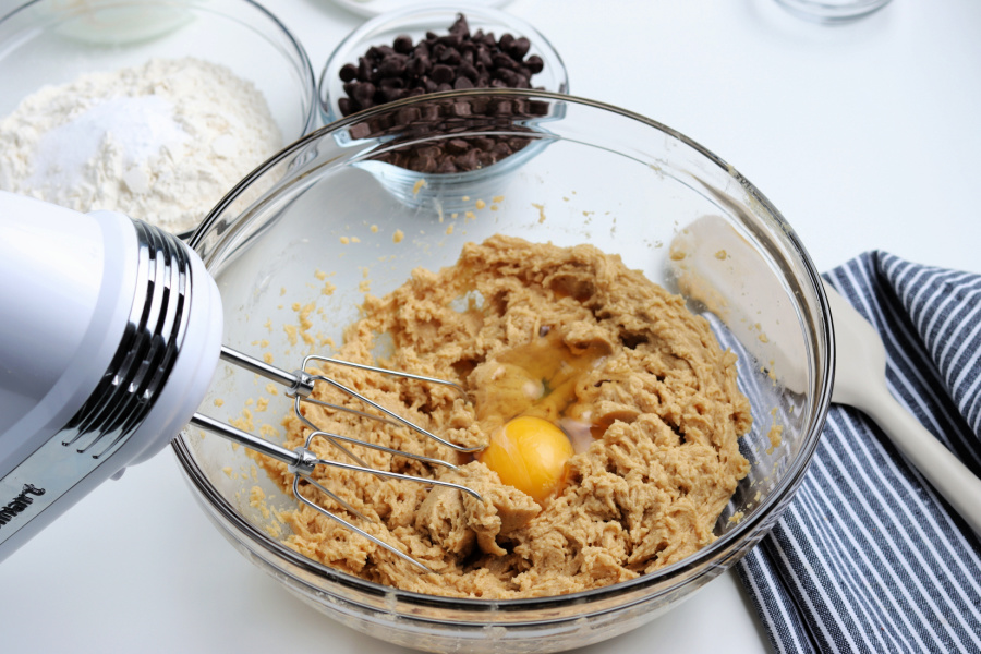 egg being added to cookie batter