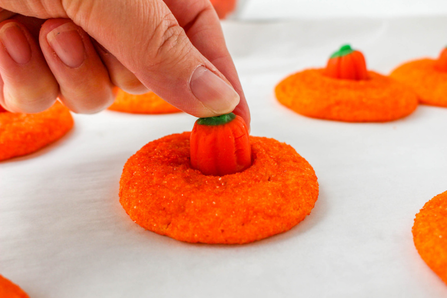 pushing a pumpkin cookie into cookie